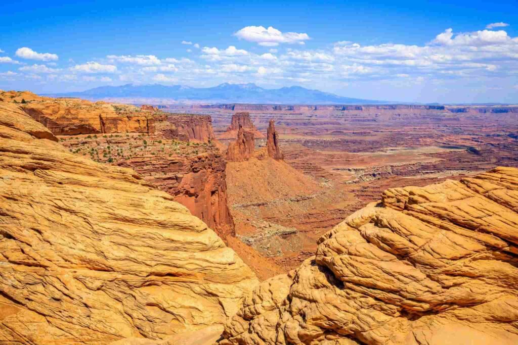 Visitors exploring National Park under a clear blue summer sky in Utah.
