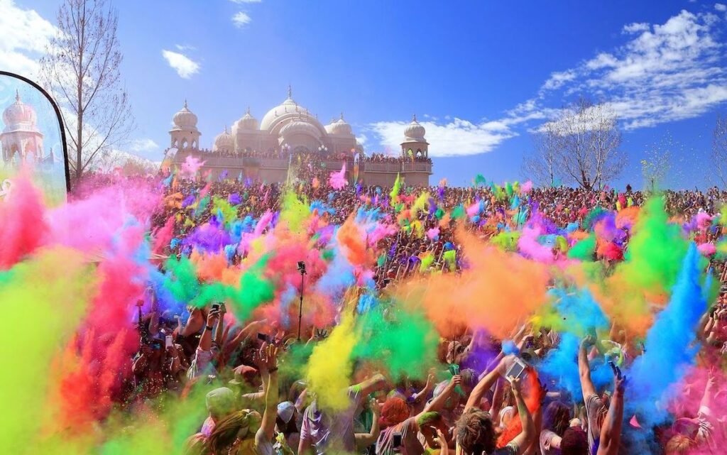 People celebrating Holi festival with vibrant colors in India